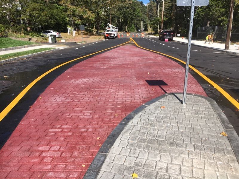 A street with a red curb and yellow lines on it