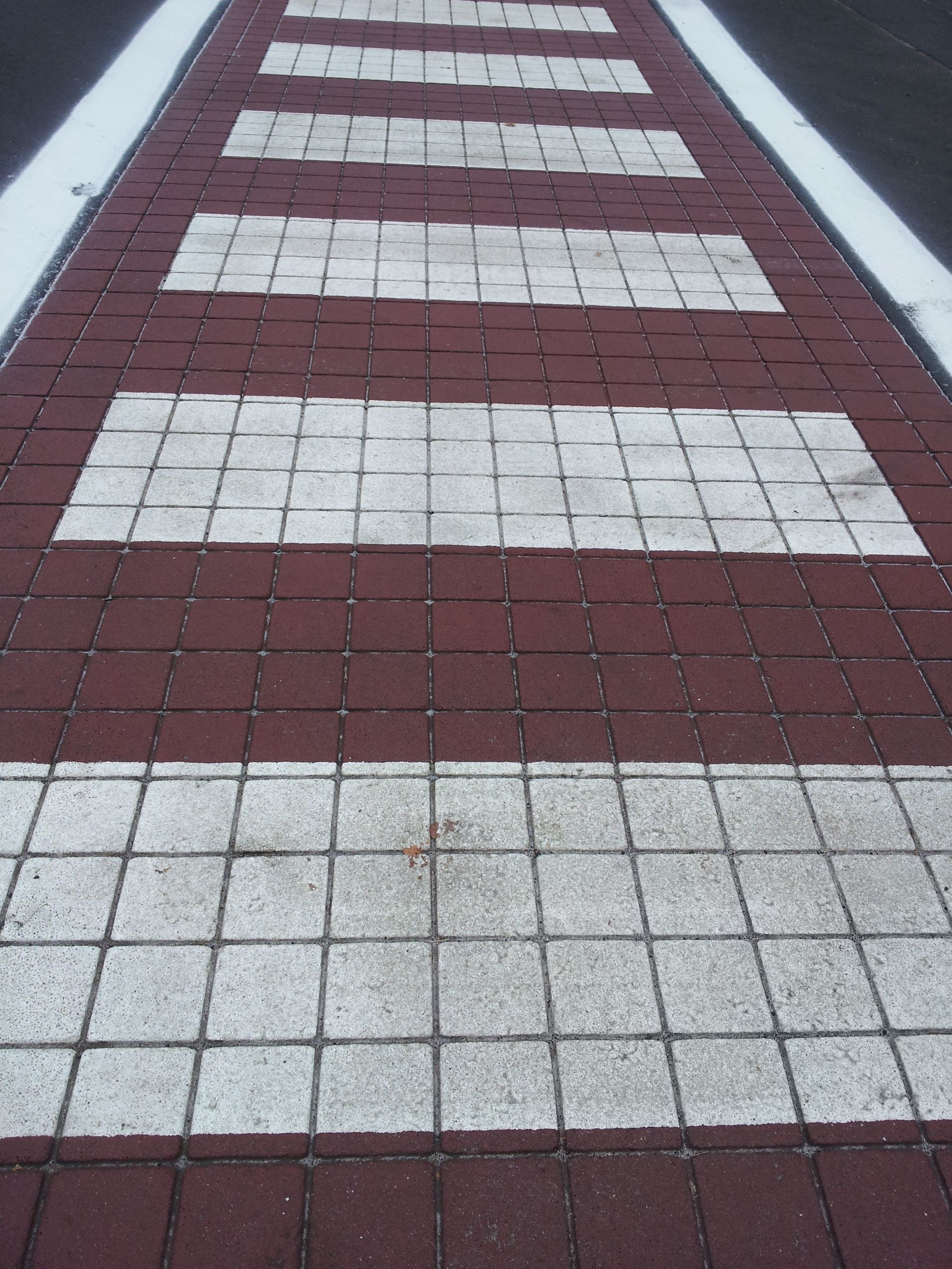 A red and white crosswalk with white lines on it