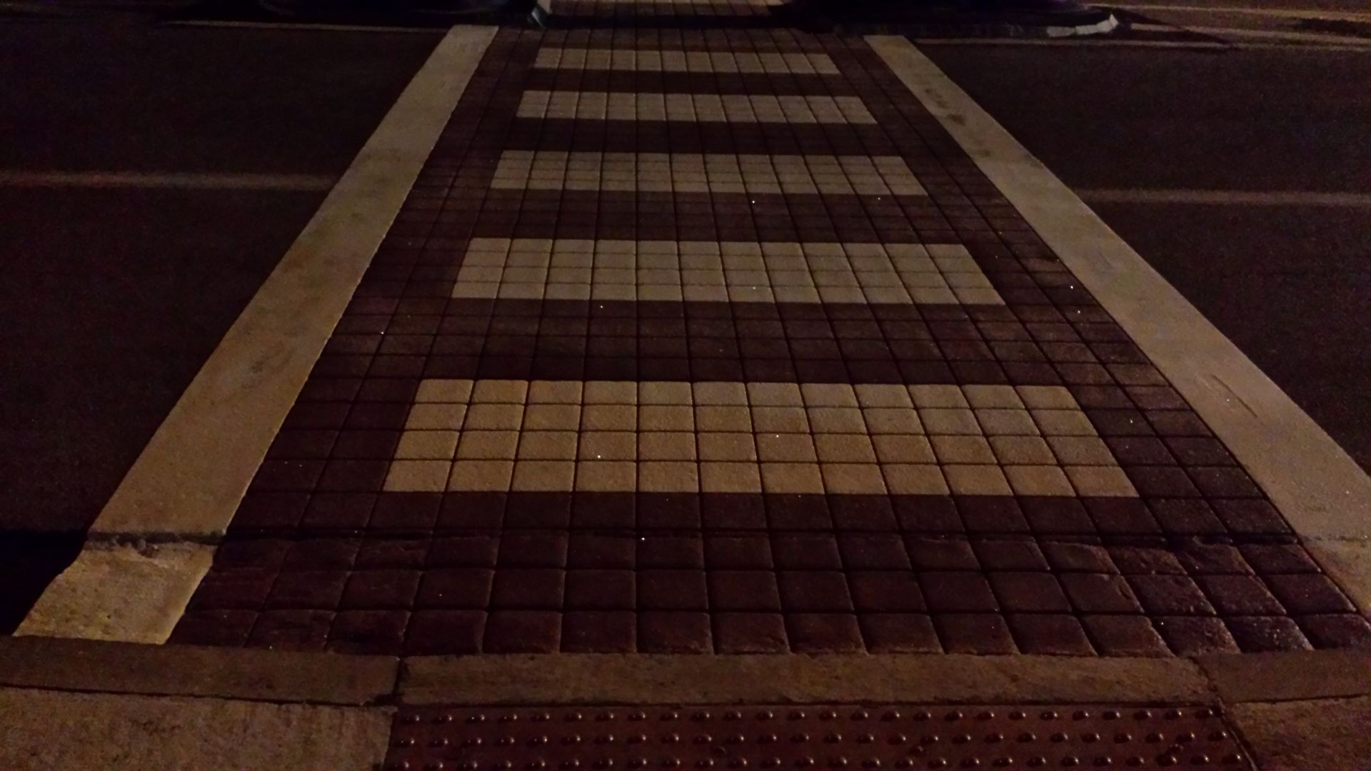 A crosswalk with a white line on the side of it