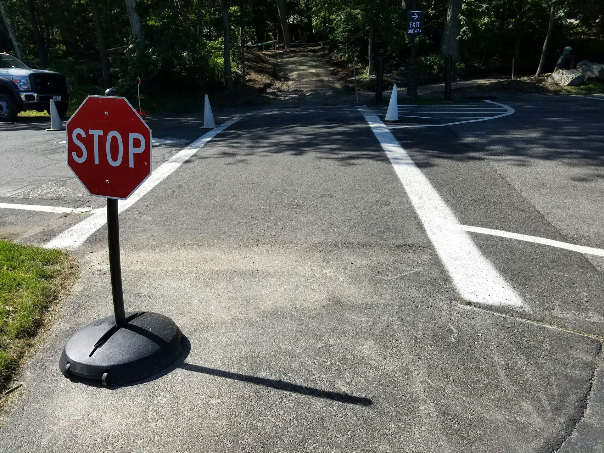 A stop sign is sitting on the side of a road.