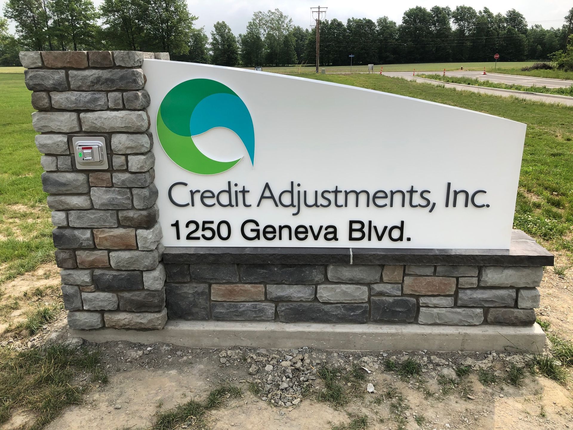 A sign for credit adjustments inc. on 1250 geneva blvd.