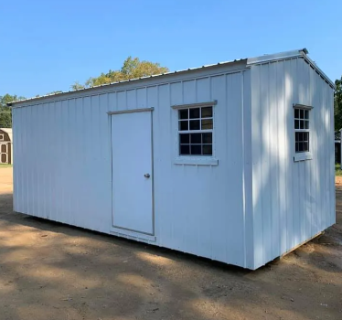 Small white portable shed with a door and two windows on a dirt lot