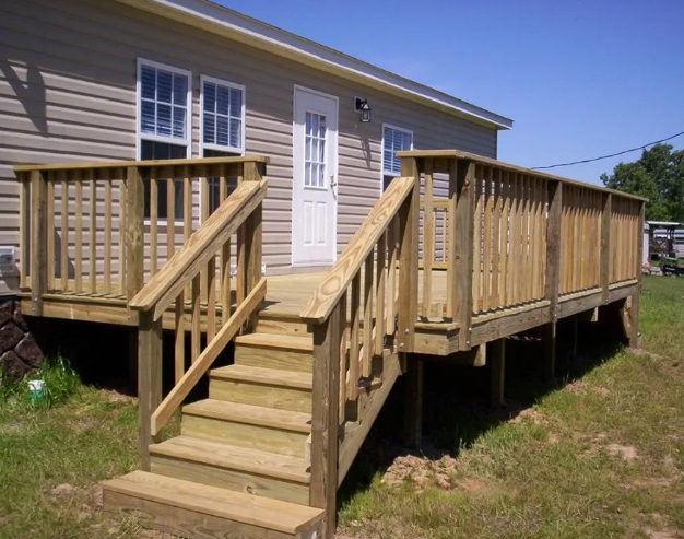 Wooden front porch ramp and stairs leading to a house entrance