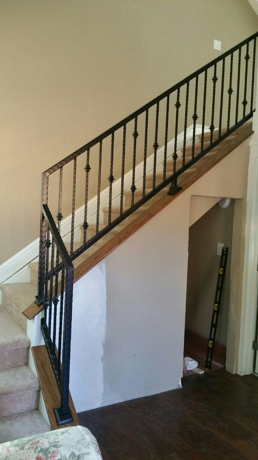 A staircase with a wrought iron railing in a living room