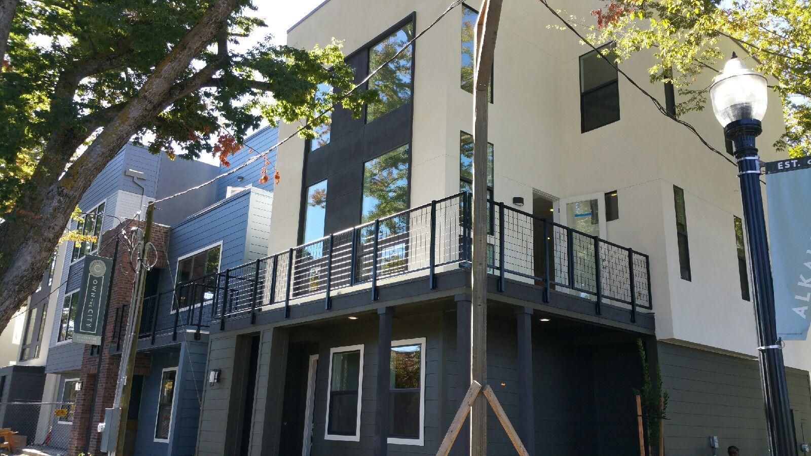 A black and white building with a balcony on the side of it
