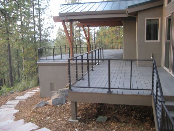 A house with a large deck with a metal railing