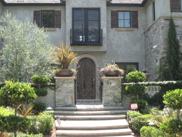 A large house with stairs leading up to the front door