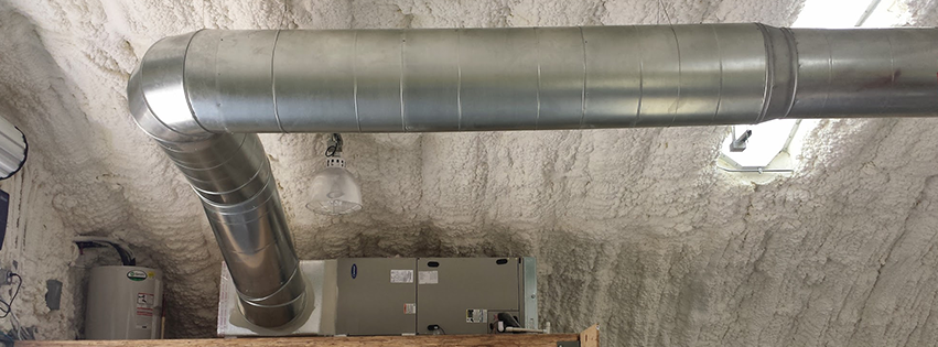 A metal pipe is hanging from the ceiling of a room.