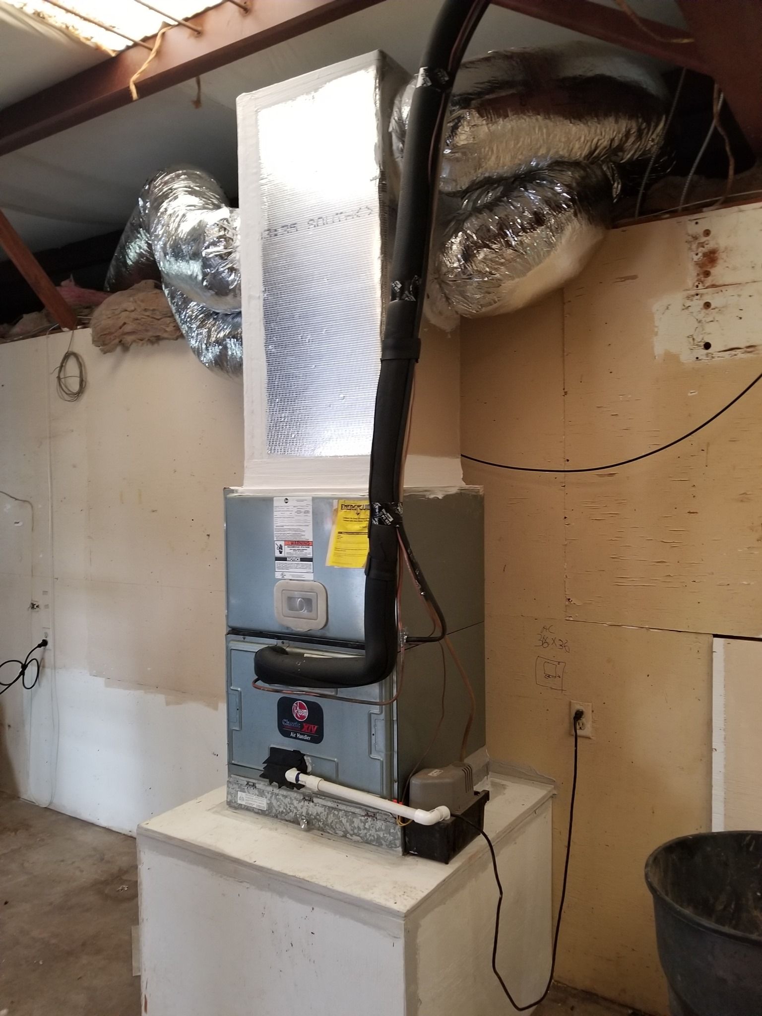 An air conditioner is sitting on top of a white table in a room.