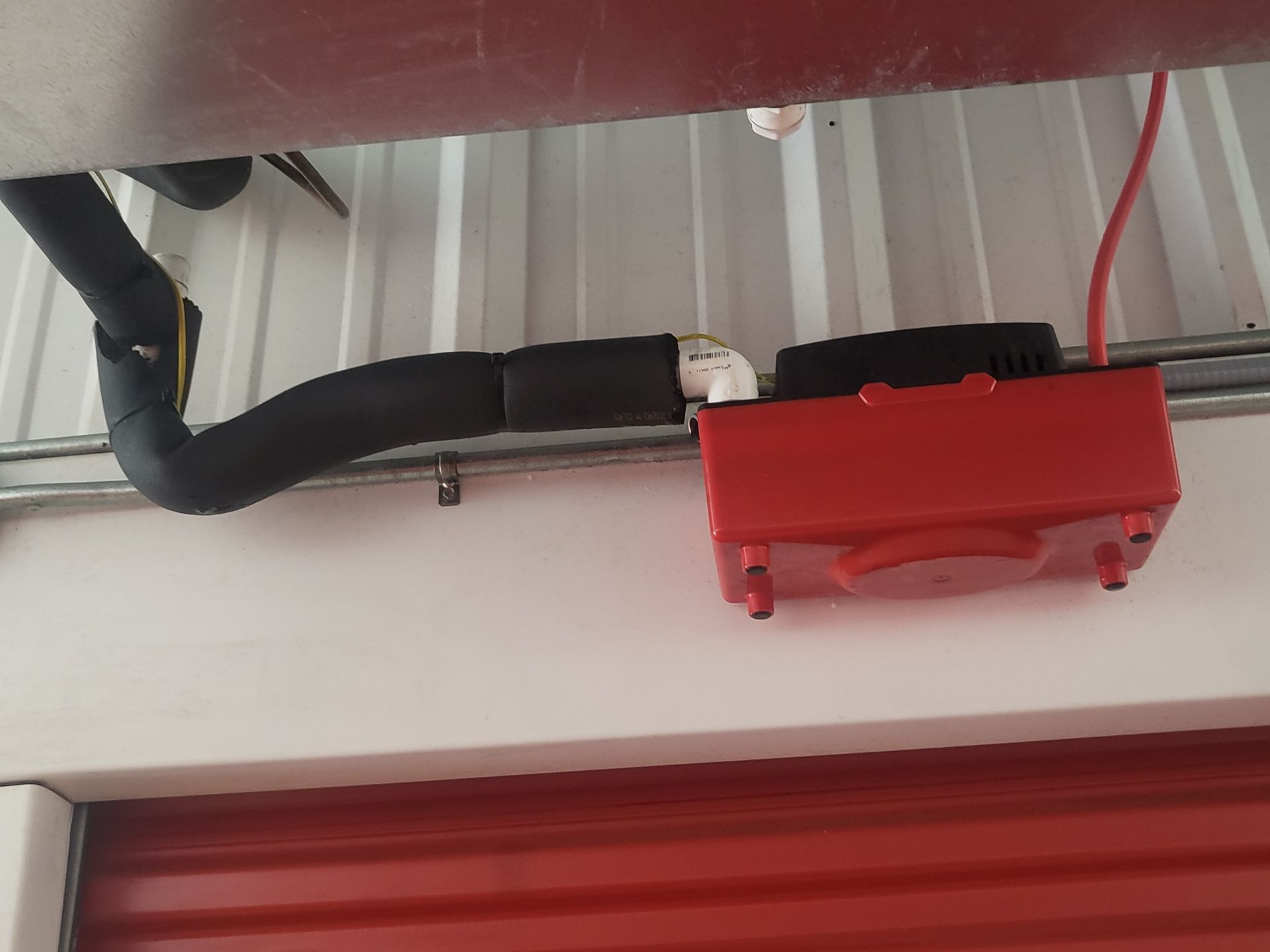 A red box is hanging from the ceiling of a building