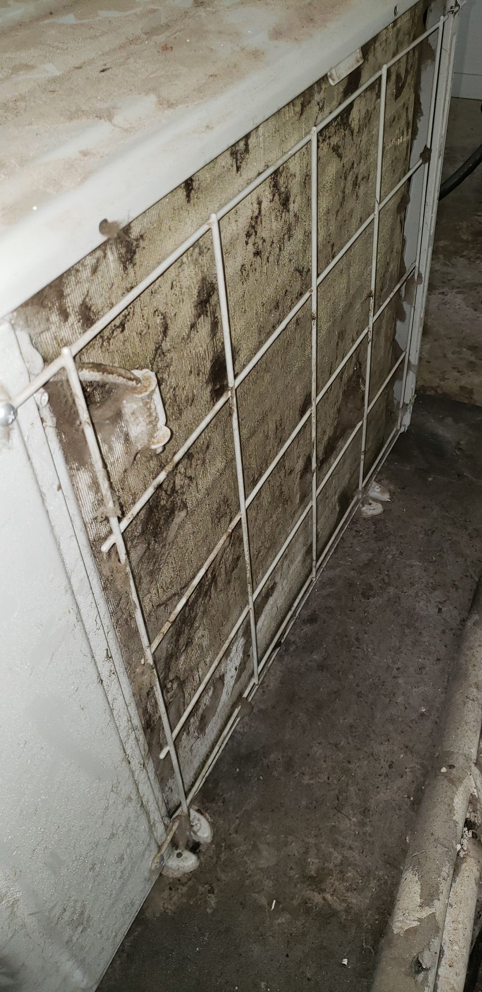 A close-up of a dirty wall with a grid on it