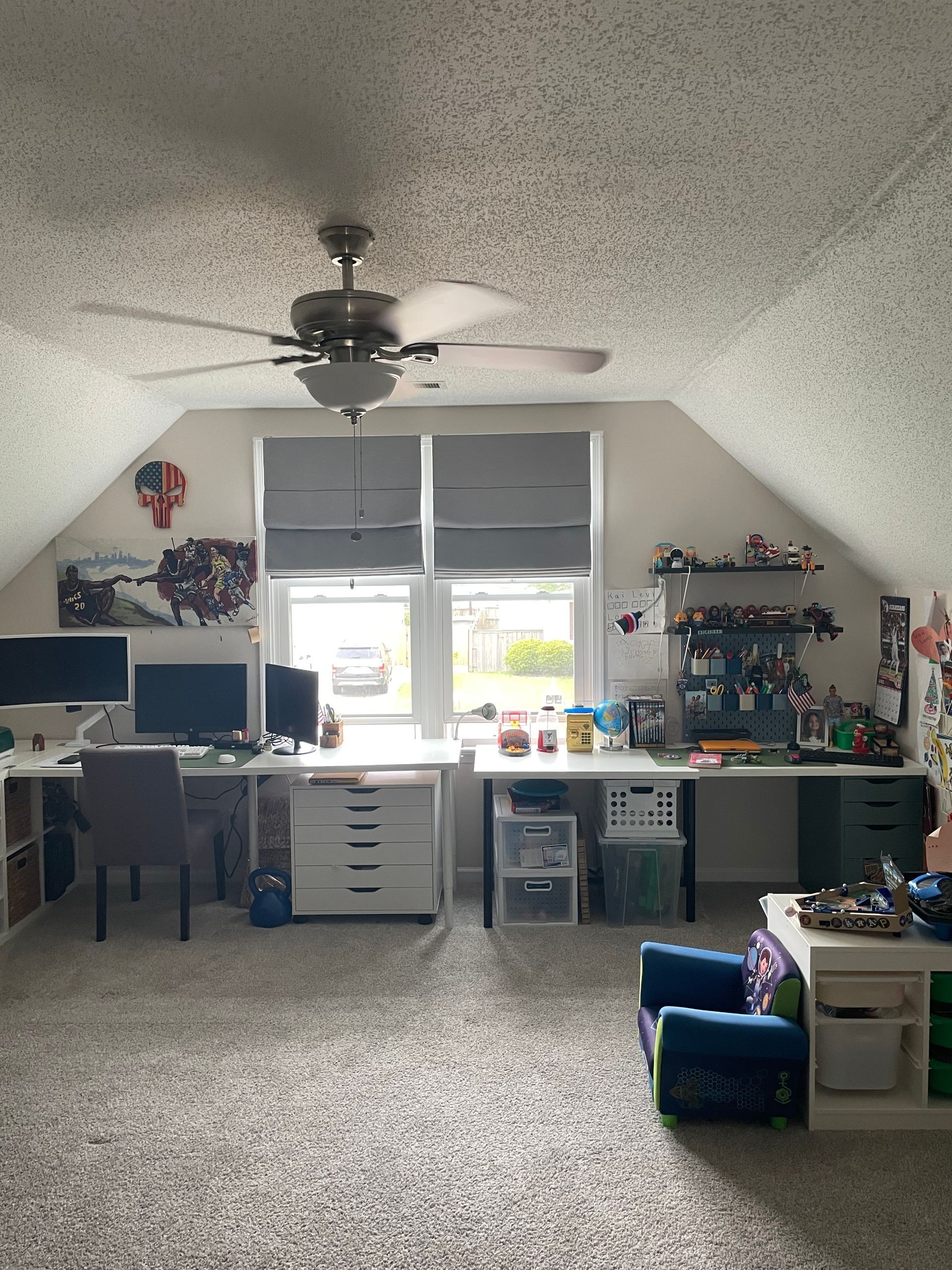 BEFORE: Bright home office with two desks, computer setup, window, ceiling fan, and organized shelves.