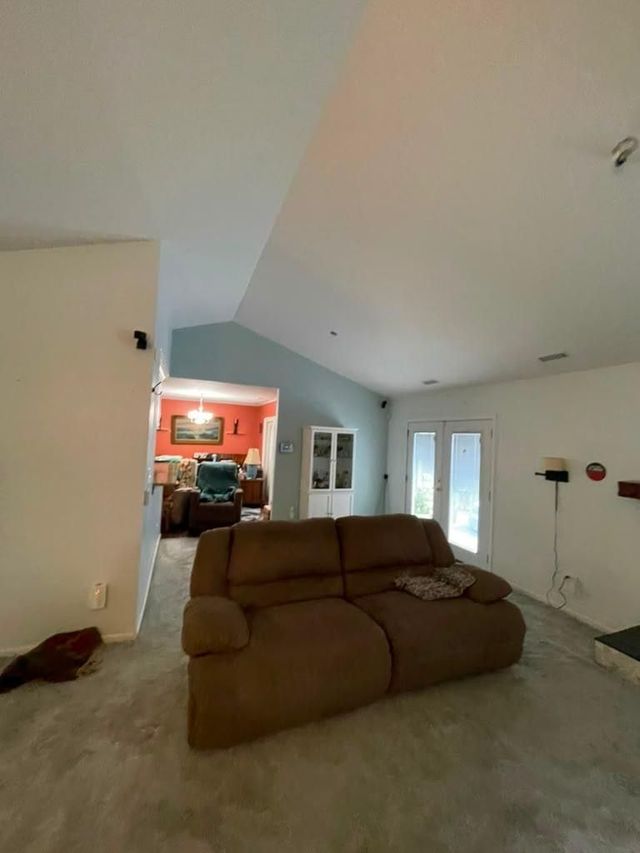 Corner of an unfinished room with a white patch on the wall and construction debris on the floor