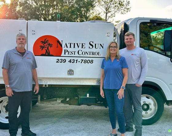 2 men and a woman in front of the truck with the nob logo