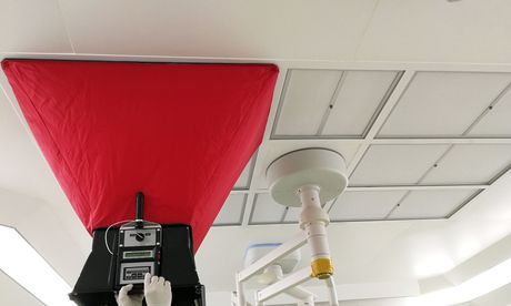 A red bag is hanging from the ceiling of a room