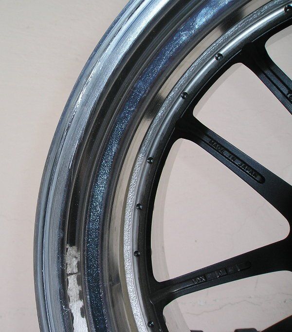 A close up of a motorcycle wheel with a silver rim