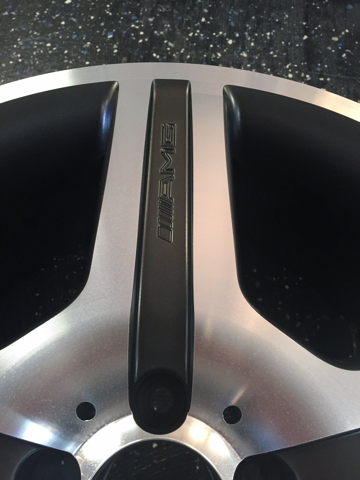 A close up of a wheel with the word amg on it