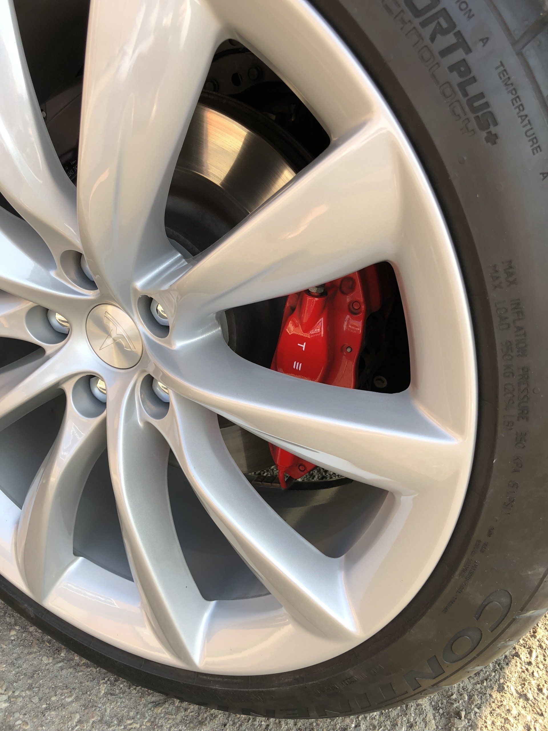 A close up of a car wheel with red brake calipers