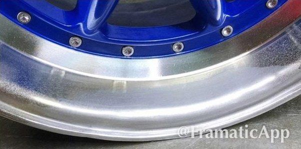 A close up of a blue wheel with a silver rim