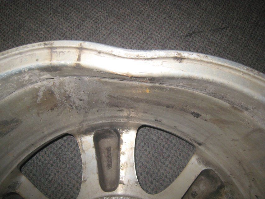 A close up of a broken wheel on a carpet