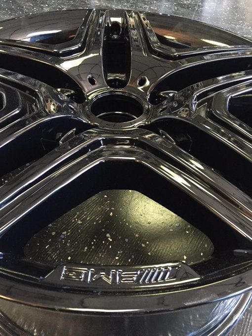 A close up of a black rim with the word amg on it.
