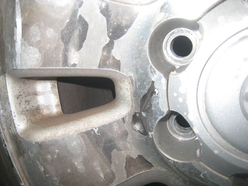 A close up of a car wheel with a hole in it