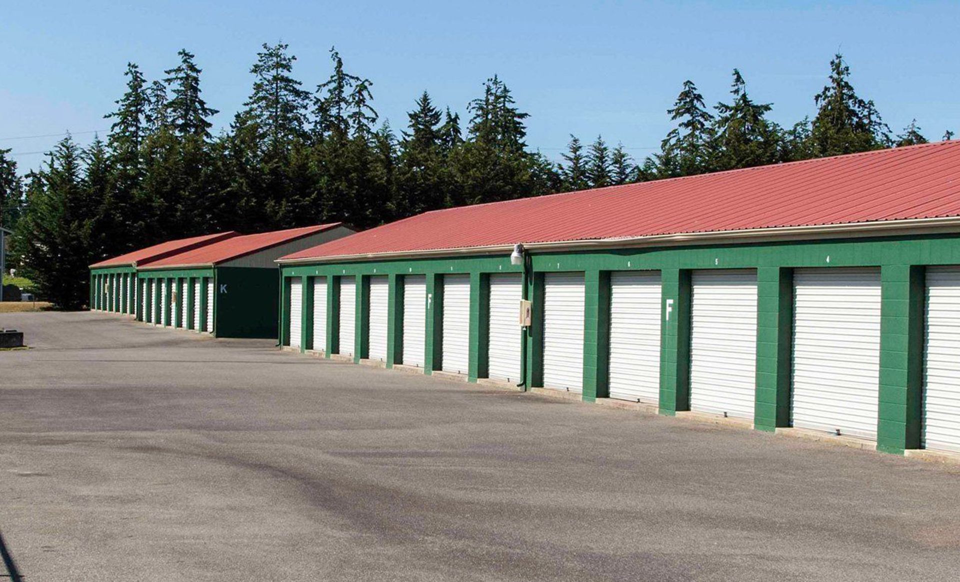 a row of green and white Mini storages