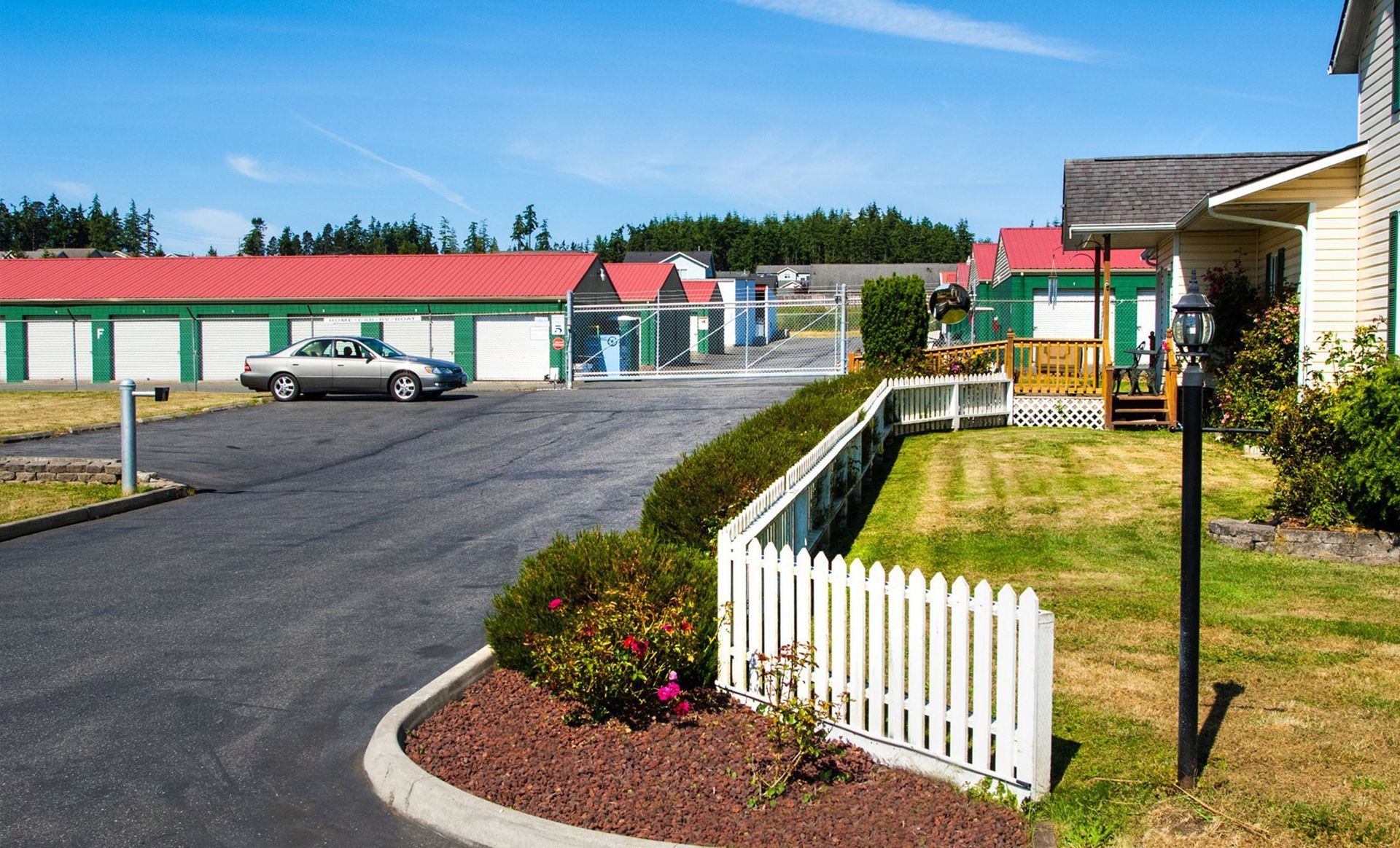 a car is parked in a driveway in front of Storage Facility