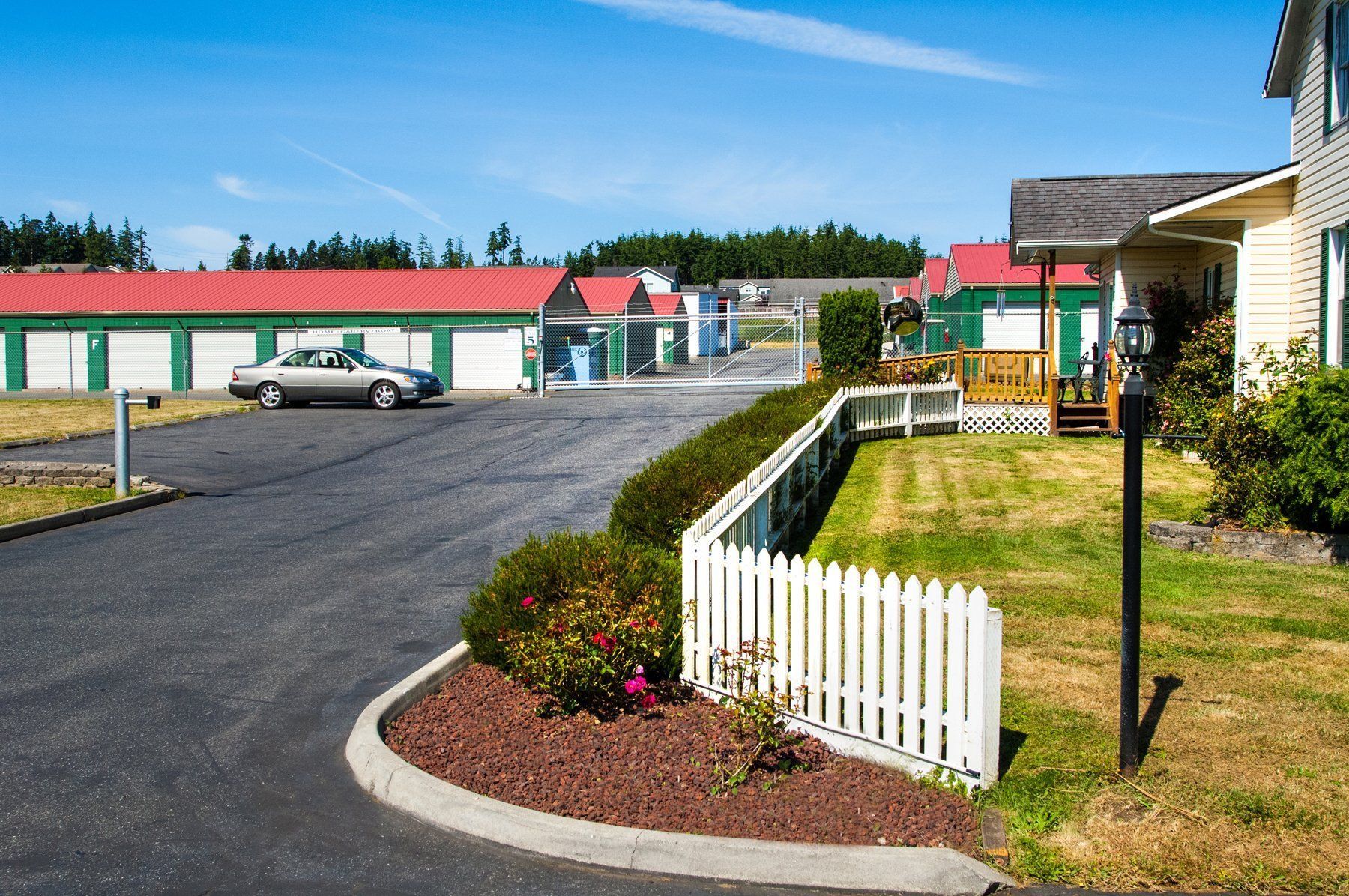 a white picket fence is in front of a house