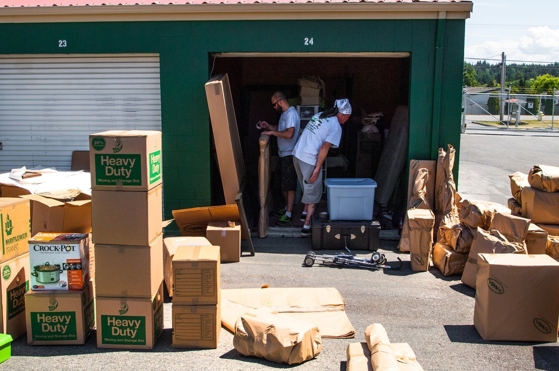 a stack of heavy duty boxes in front of a garage
