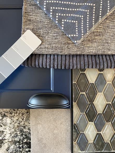 Navy and gray color scheme for kitchen remodel with fabric swatches, paint chips, and cabinet hardware.