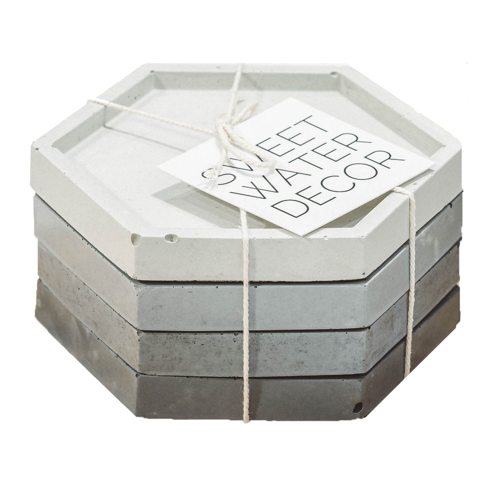 Stack of hexagonal concrete coasters in varying shades of gray, tied with twine and a tag.