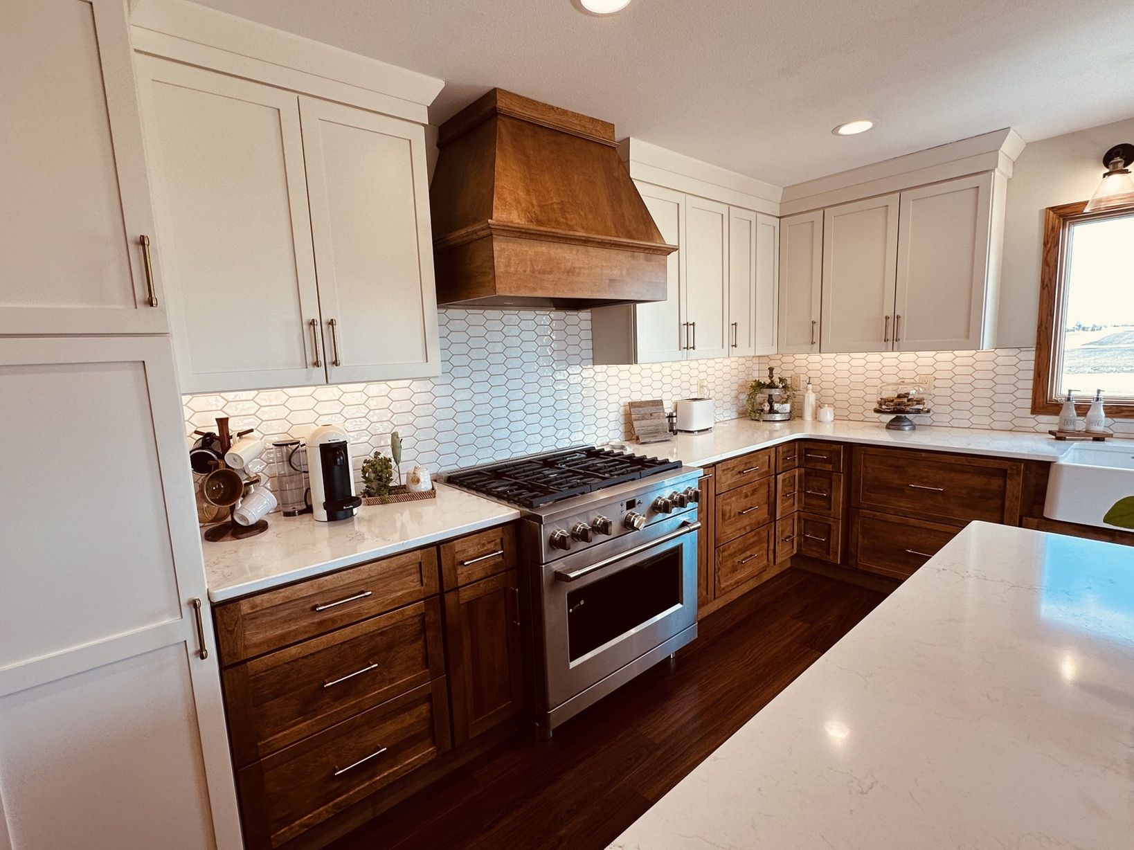A kitchen with stainless steel appliances and wooden cabinets.