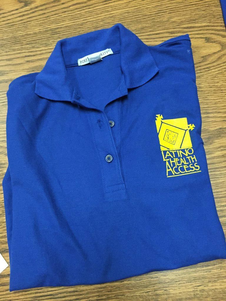 A blue polo shirt with a yellow logo that says saving Latino Health Access