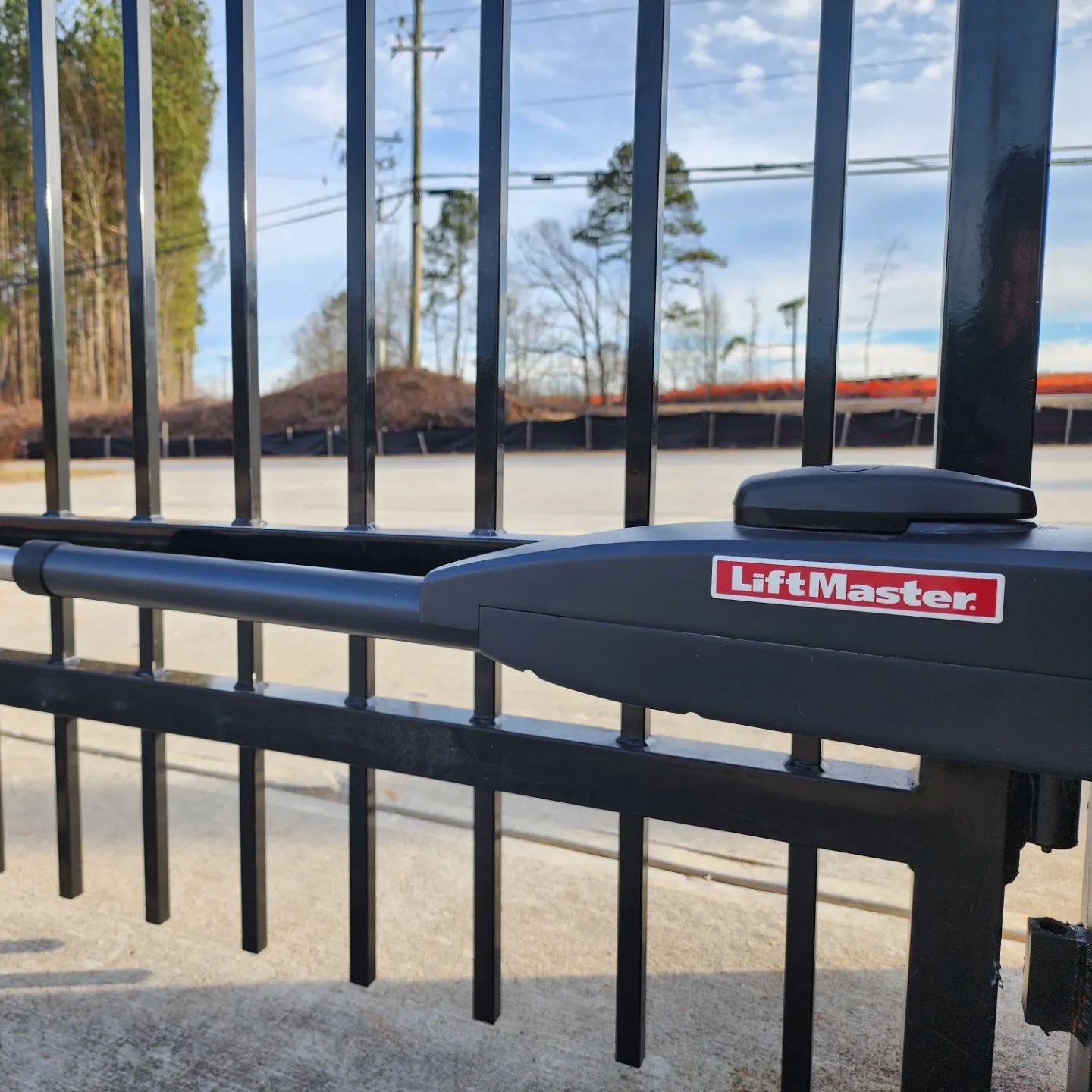 A black gate with a lift master logo on it