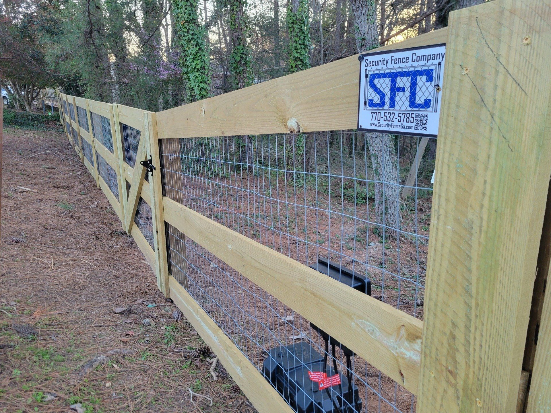 A wooden fence with a sign attached to it.