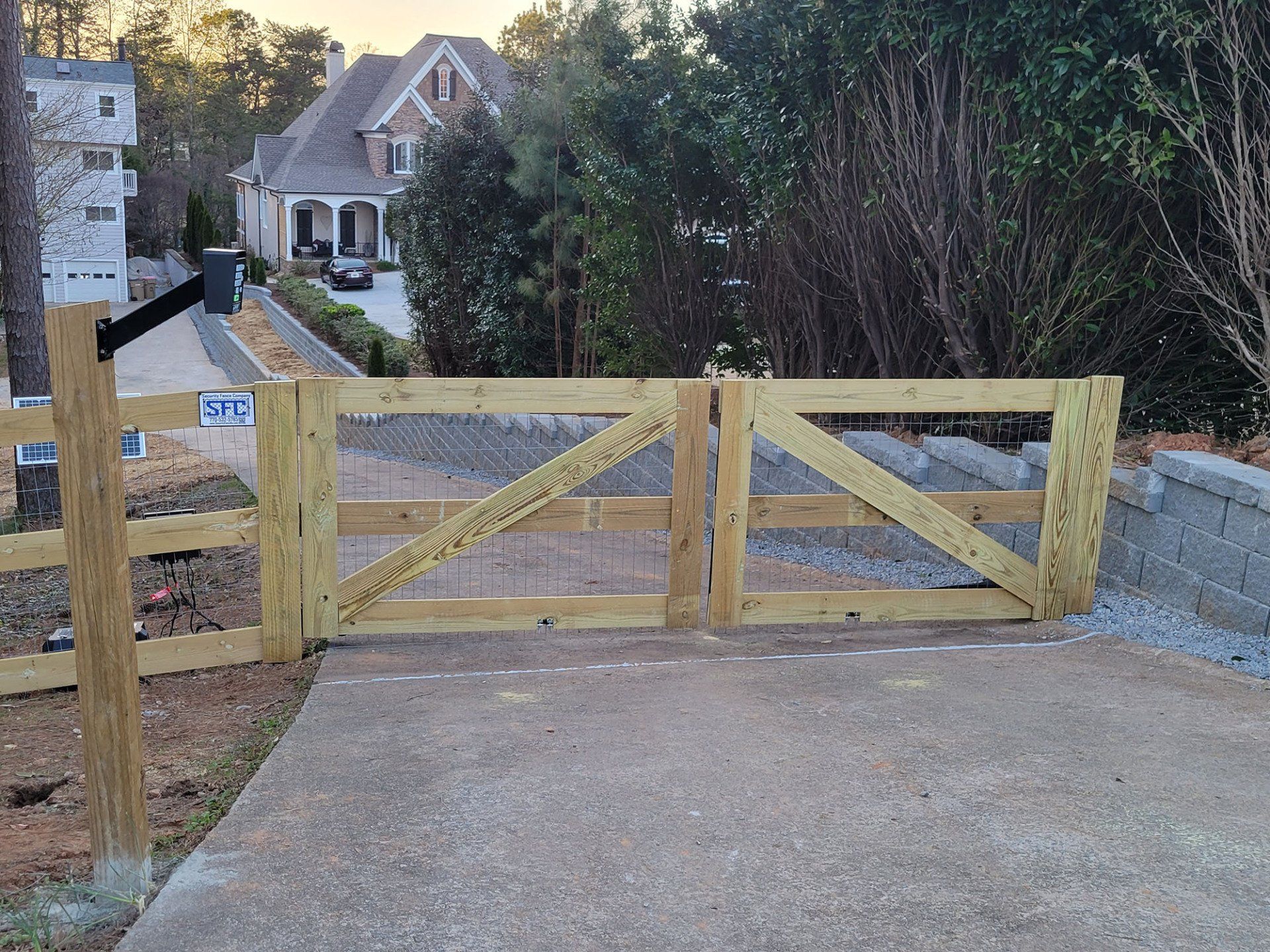 A wooden gate with a house in the background