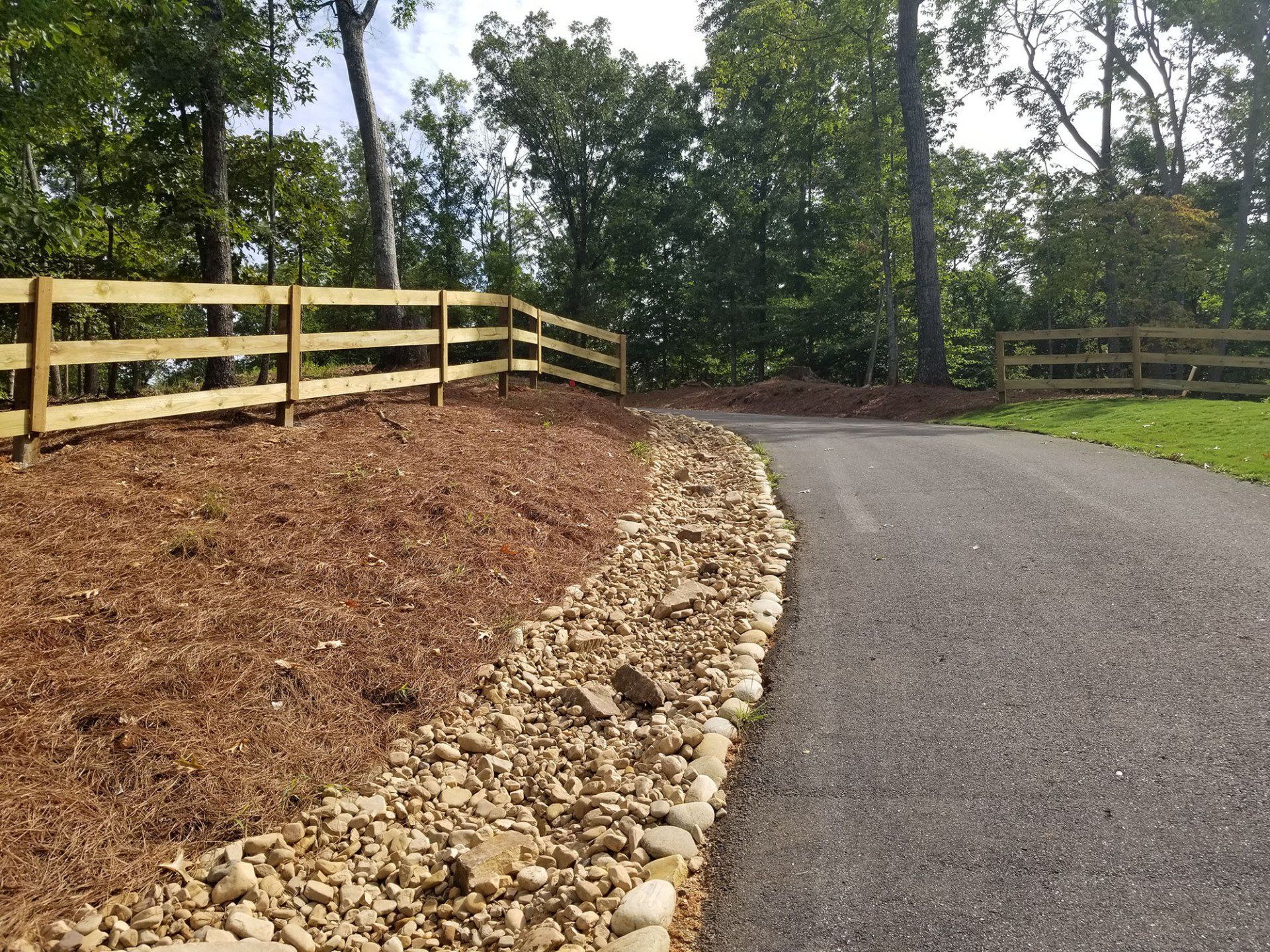 A wooden fence along the side of a road
