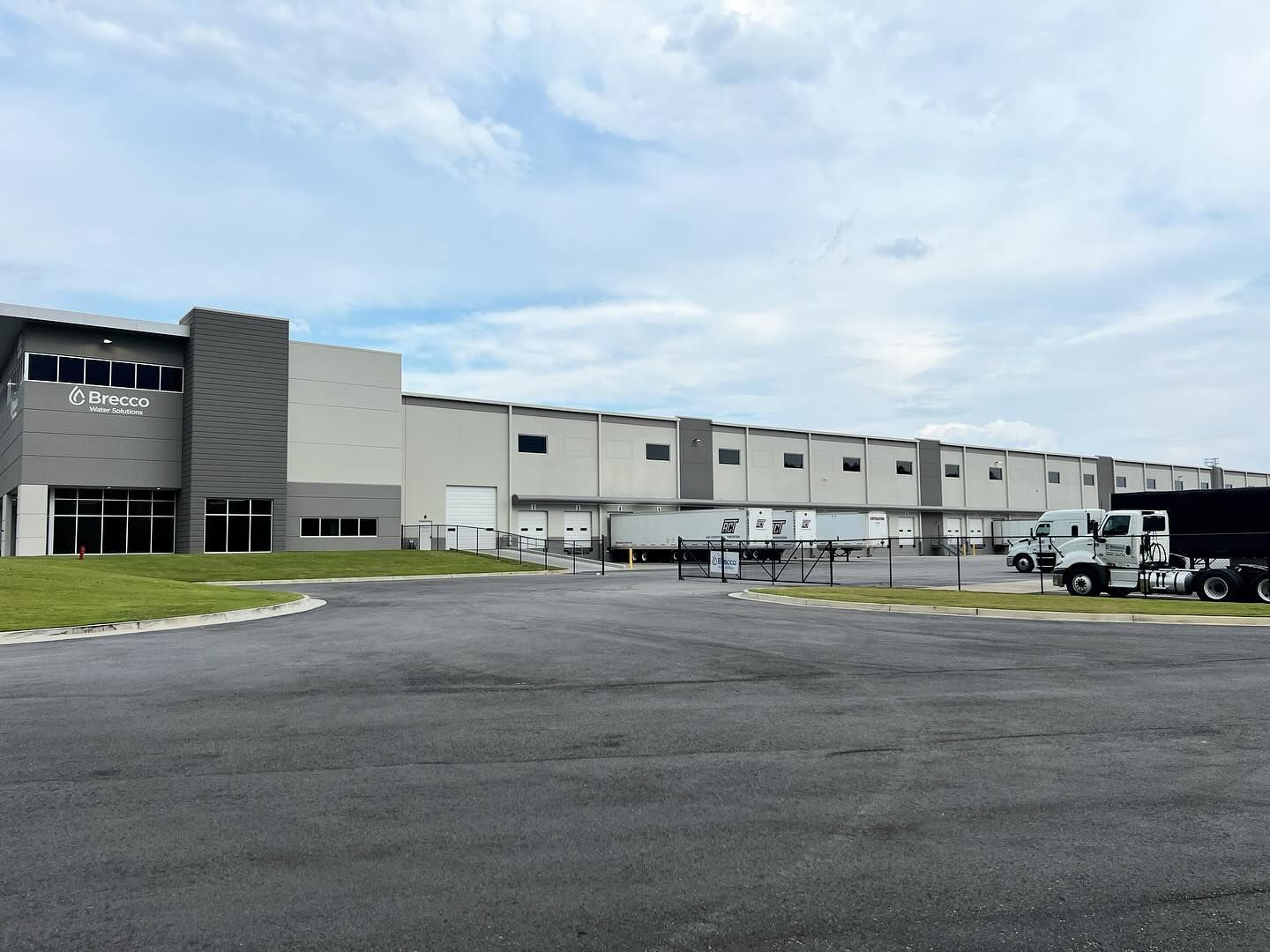 A large building with trucks parked in front of it