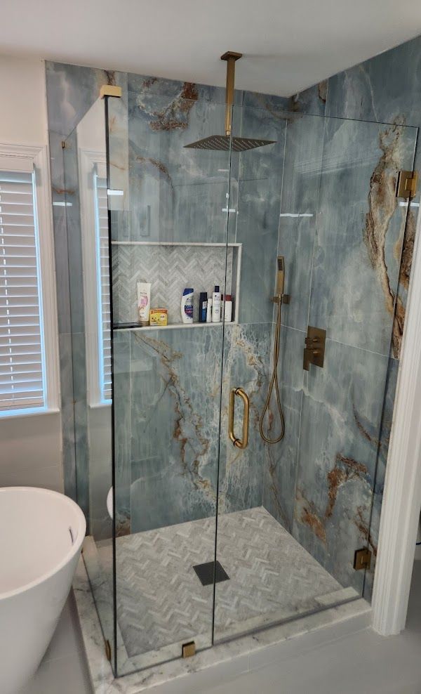 A bathroom with a walk in shower and a bathtub