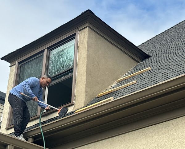 A man is working on the roof of a house