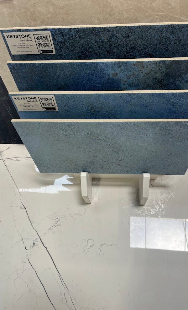 Three blue tiles are stacked on top of each other on a stand