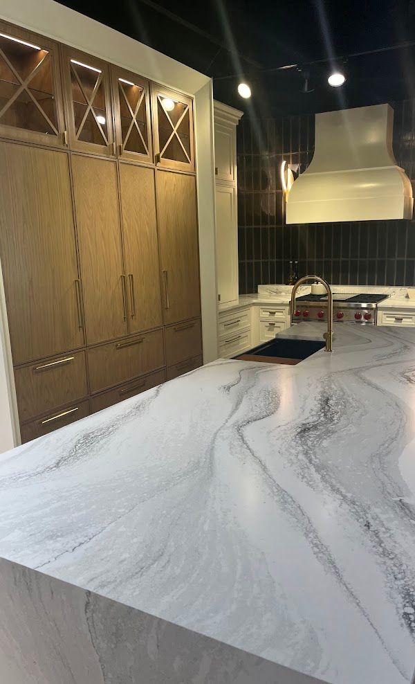 A kitchen with a large white counter top and wooden cabinets