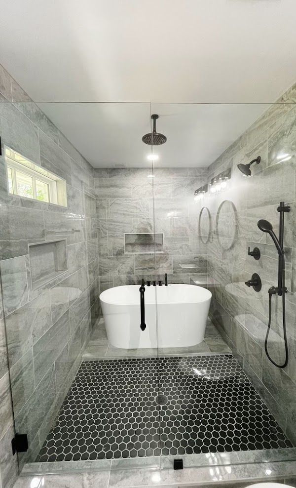 A bathroom with a bathtub and a walk in shower