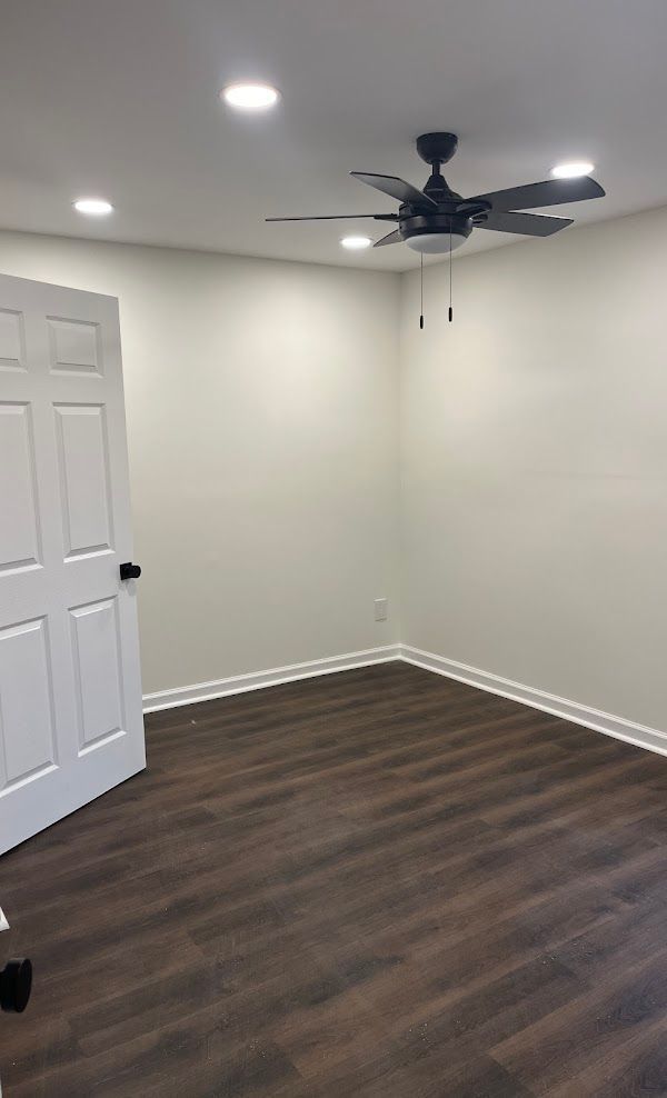 There is a ceiling fan in the corner of the room