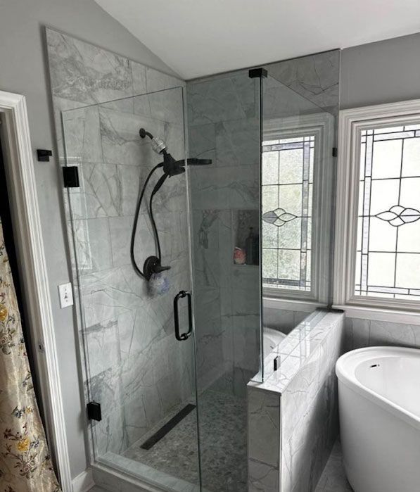 A bathroom with a walk in shower and a bathtub