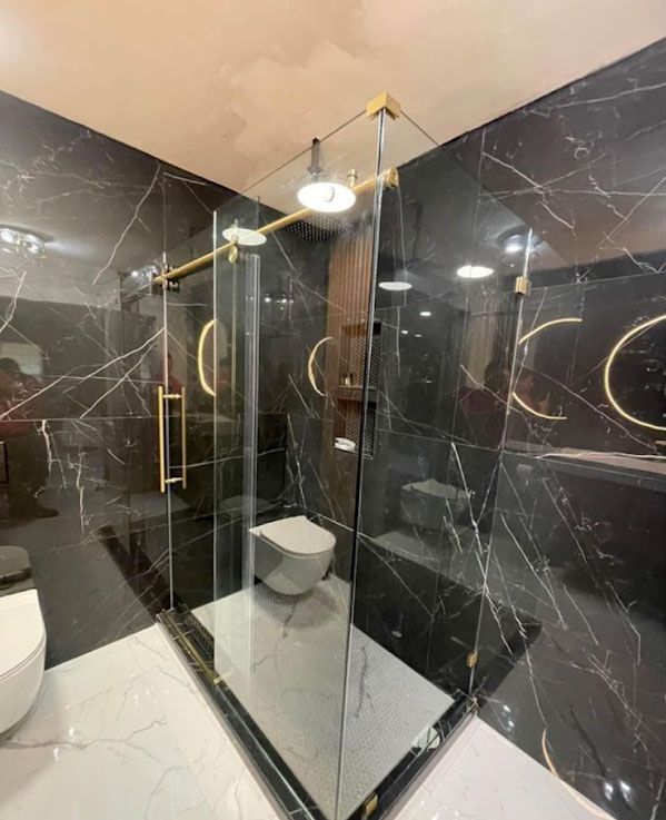A bathroom with a toilet , sink and shower stall