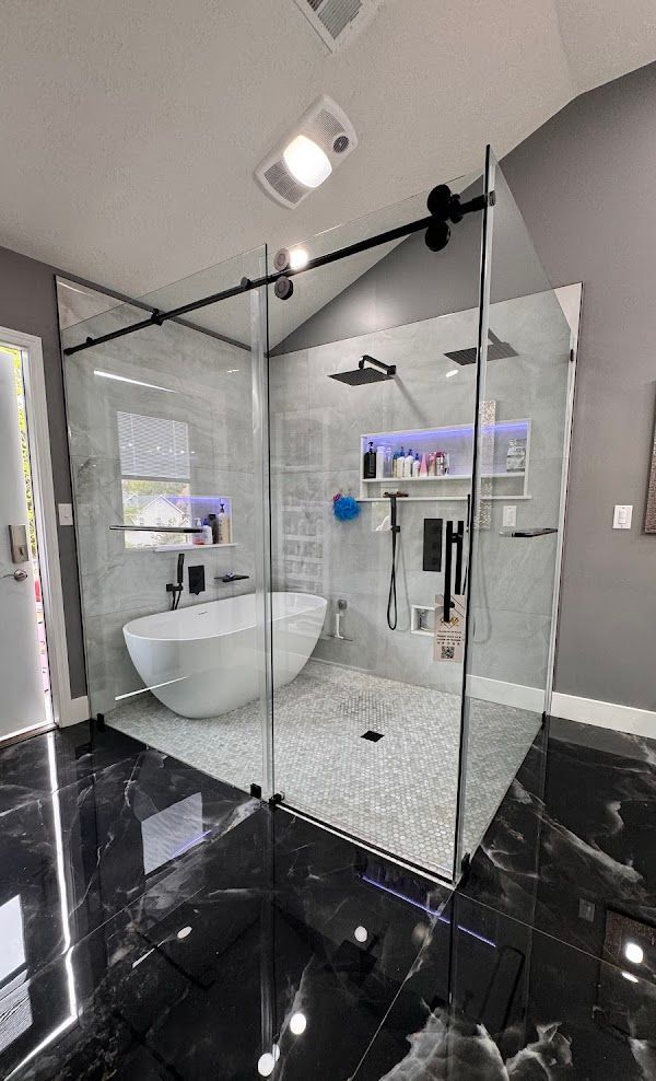 A bathroom with a bathtub and a walk in shower