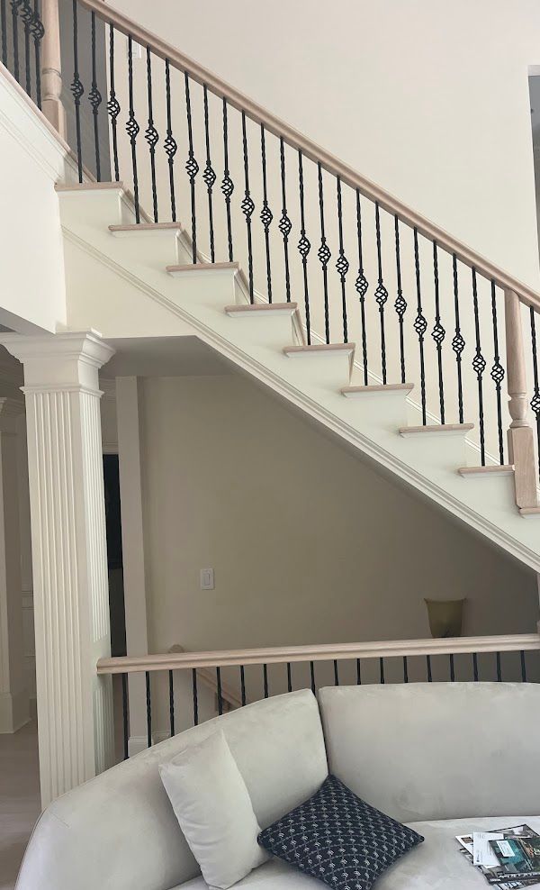 A living room with a staircase and a couch