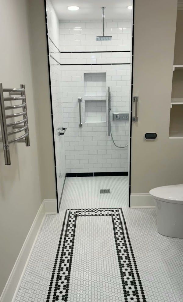 A bathroom with a walk in shower and a toilet